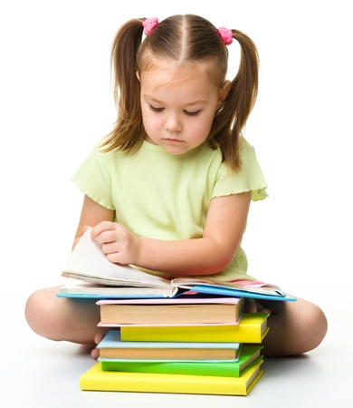 Cute little girl reads a book, isolated over white (reading, child, school) @Serhiy Kobyakov